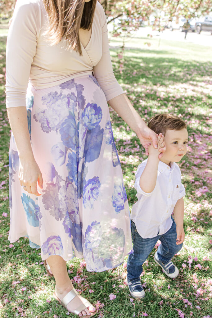 Mom and son holding hands and walking in a park in Washington DC,
