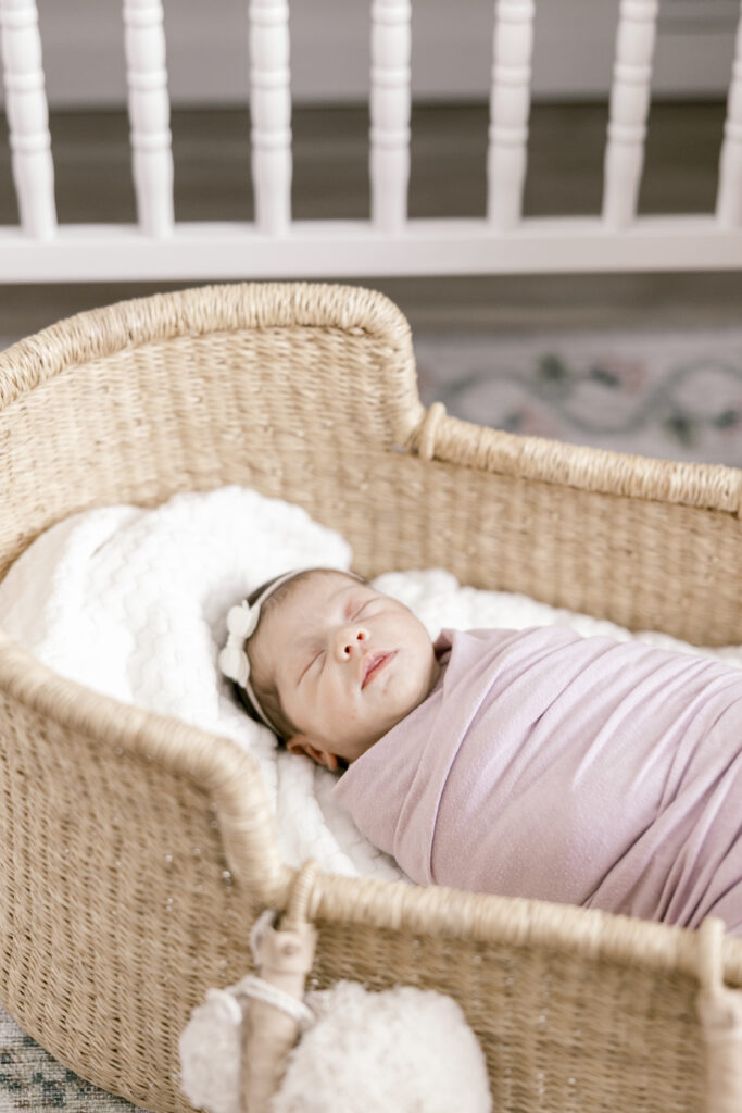 Newborn Baby Girl in Moses Basket