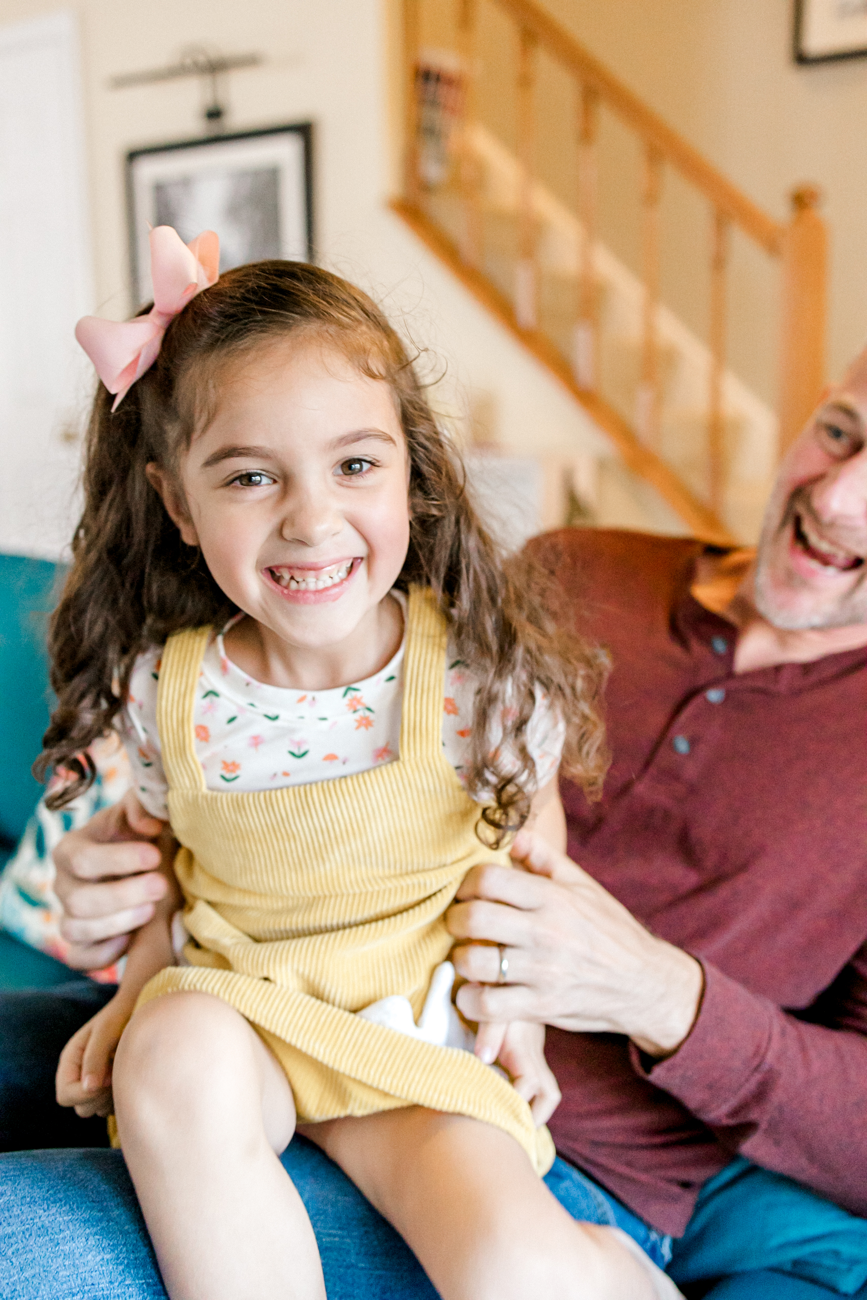 Girl smiling with dad in-home family photography