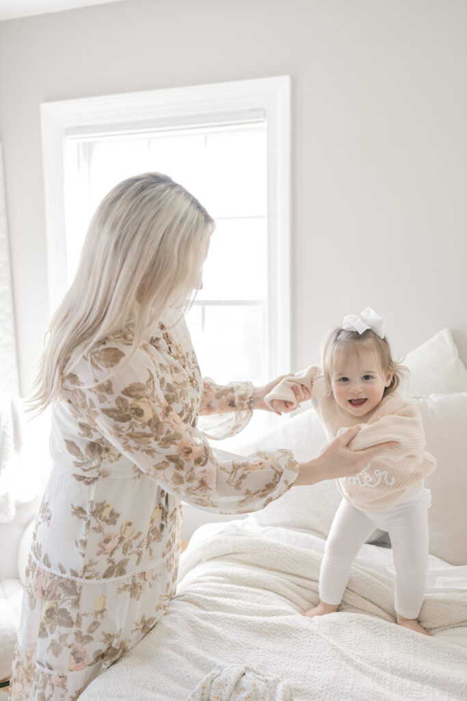 Mom and daughter playing on the bed