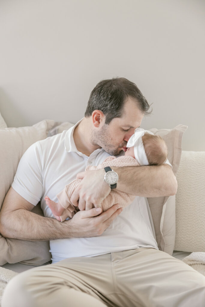 Father holding newborn during in-home session in Del Ray, Alexandria VA
