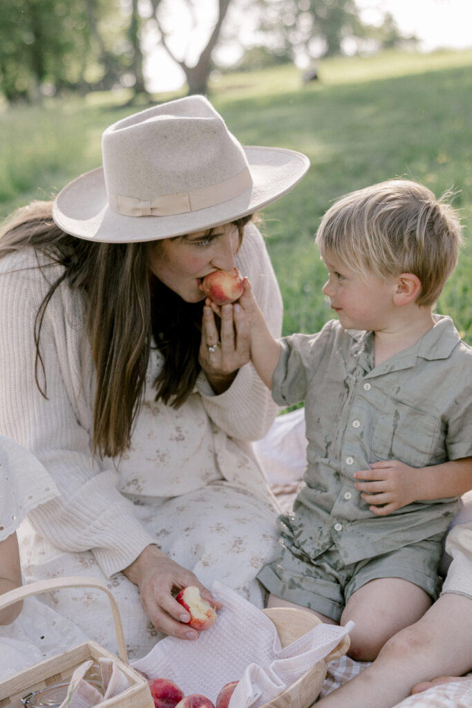 Mom and son eating a peach