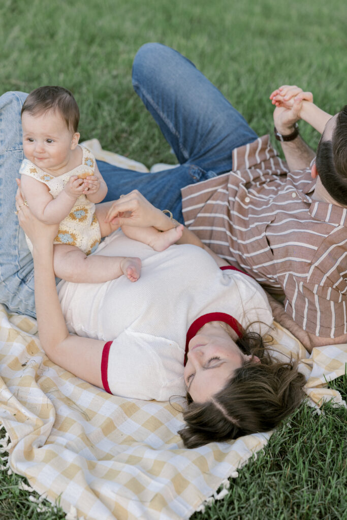 Candid moments of a family sharing snacks during a park picnic photo shoot in Alexandria, VA.