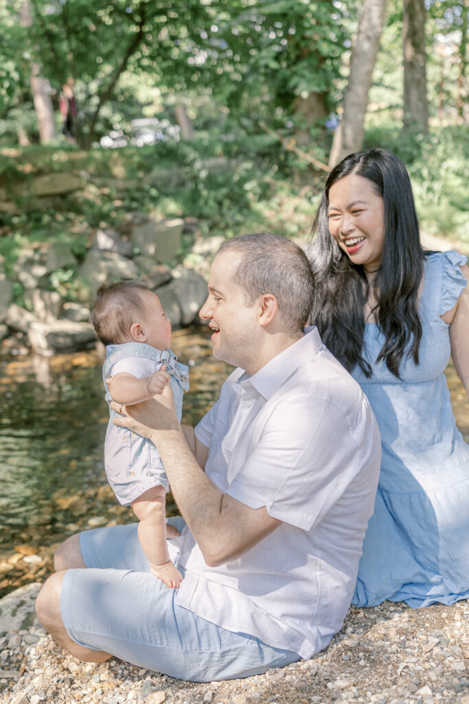 Parents and children dipping their toes into a cool creek at a Northern Virginia park.