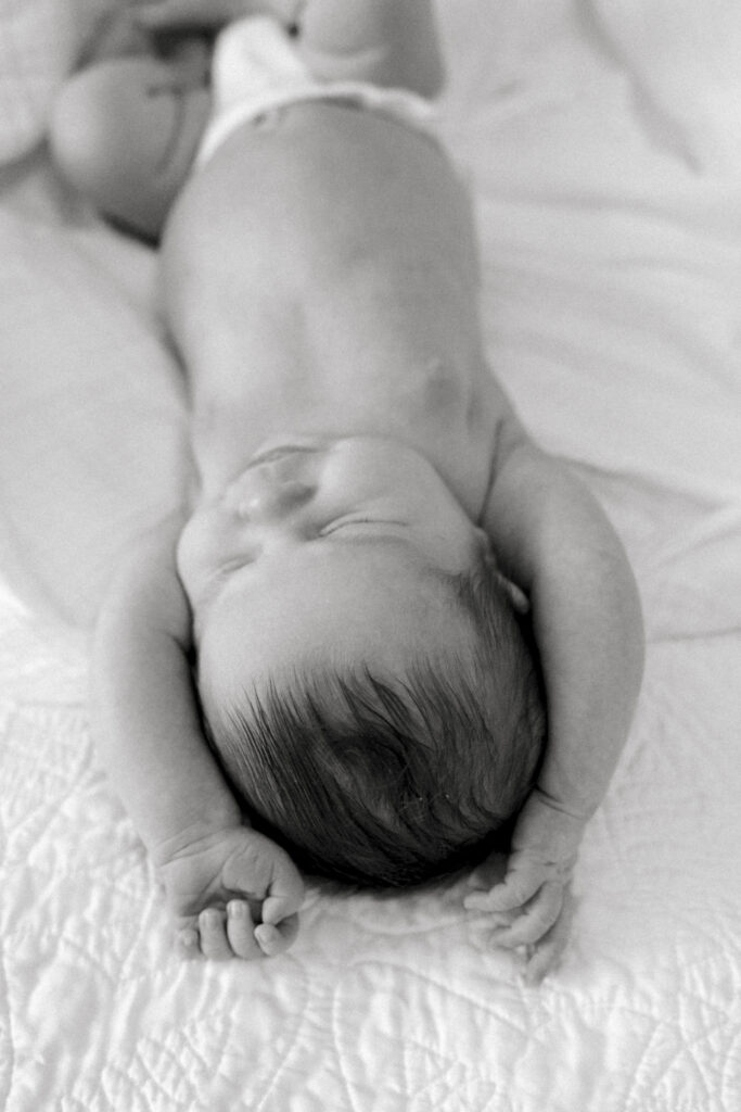 Newborn sleeping peacefully in soft natural light at home in Old Town Alexandria