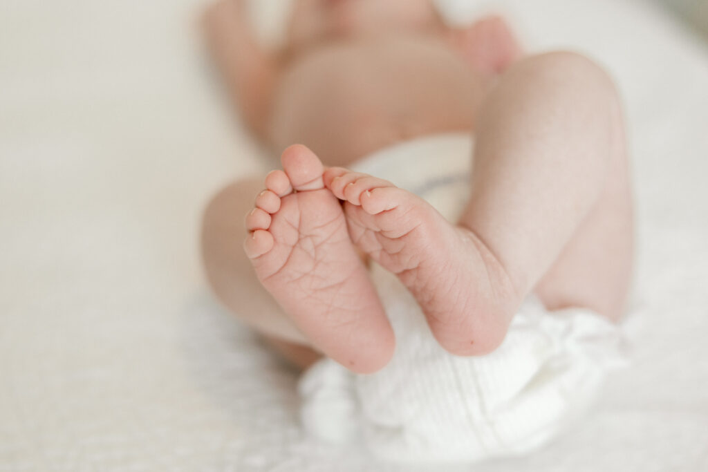 Close-up of newborn’s tiny feet during an in-home session