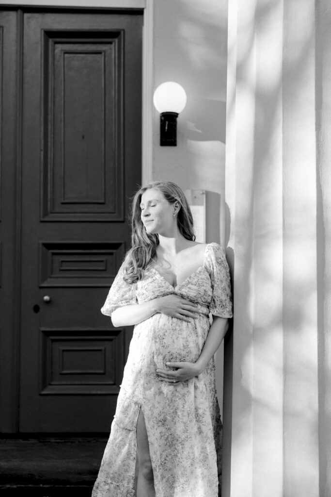 Pregnant woman posing against a building in Alexandria VA
