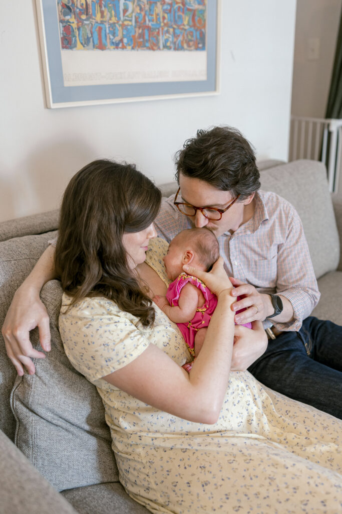 Parents cuddling infant during Washington DC lifestyle newborn session