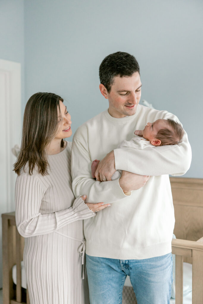 Parents with newborn baby during relaxed in-home photography session
