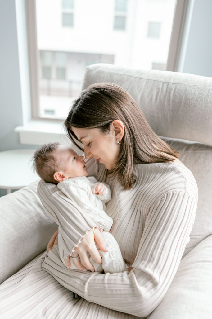 Newborn baby resting in mother’s arms during in-home session in Alexandria VA