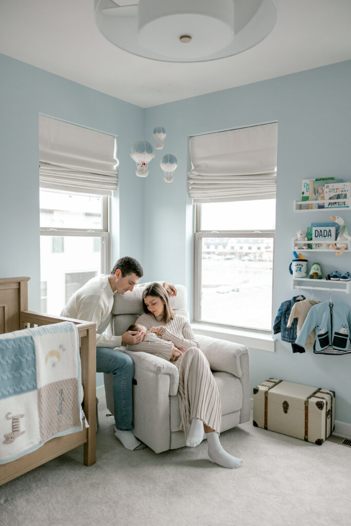 Parents with newborn baby during relaxed in-home photography session