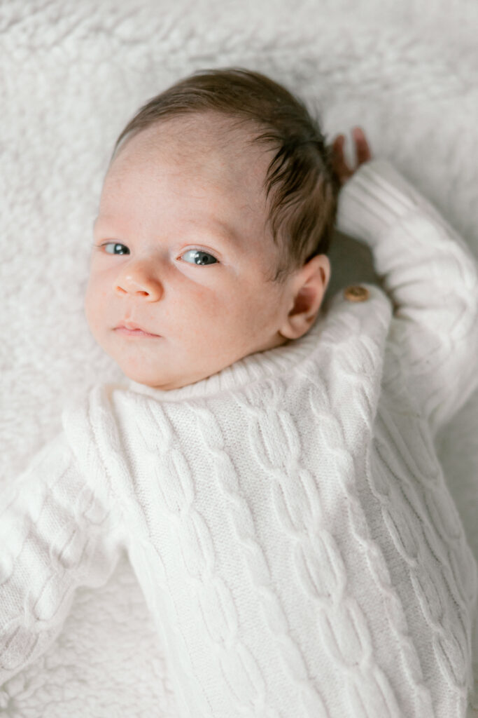 Newborn baby lying on soft blanket during in-home session in Alexandria VA