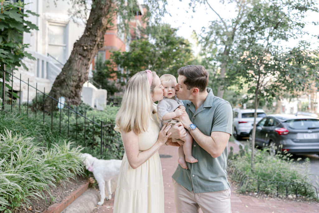 Parents kissing their baby boy in Washington DC during a family photo session.