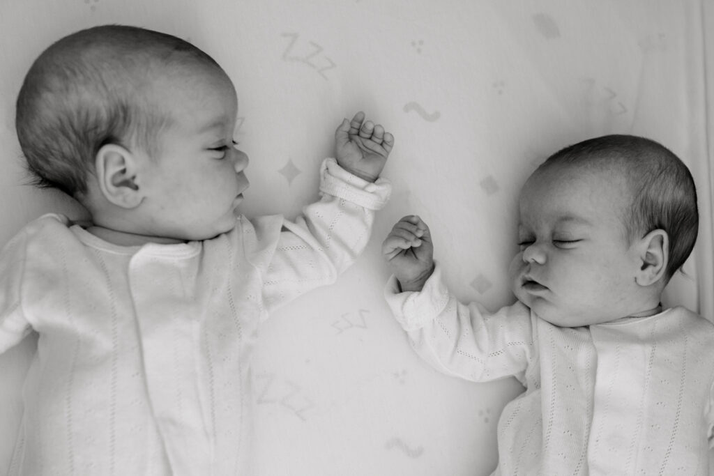 Newborn twins lying together at home during an in-home newborn session in Arlington VA